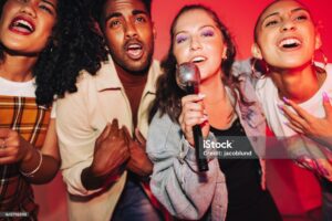 Group of friends singing karaoke together in Mississauga