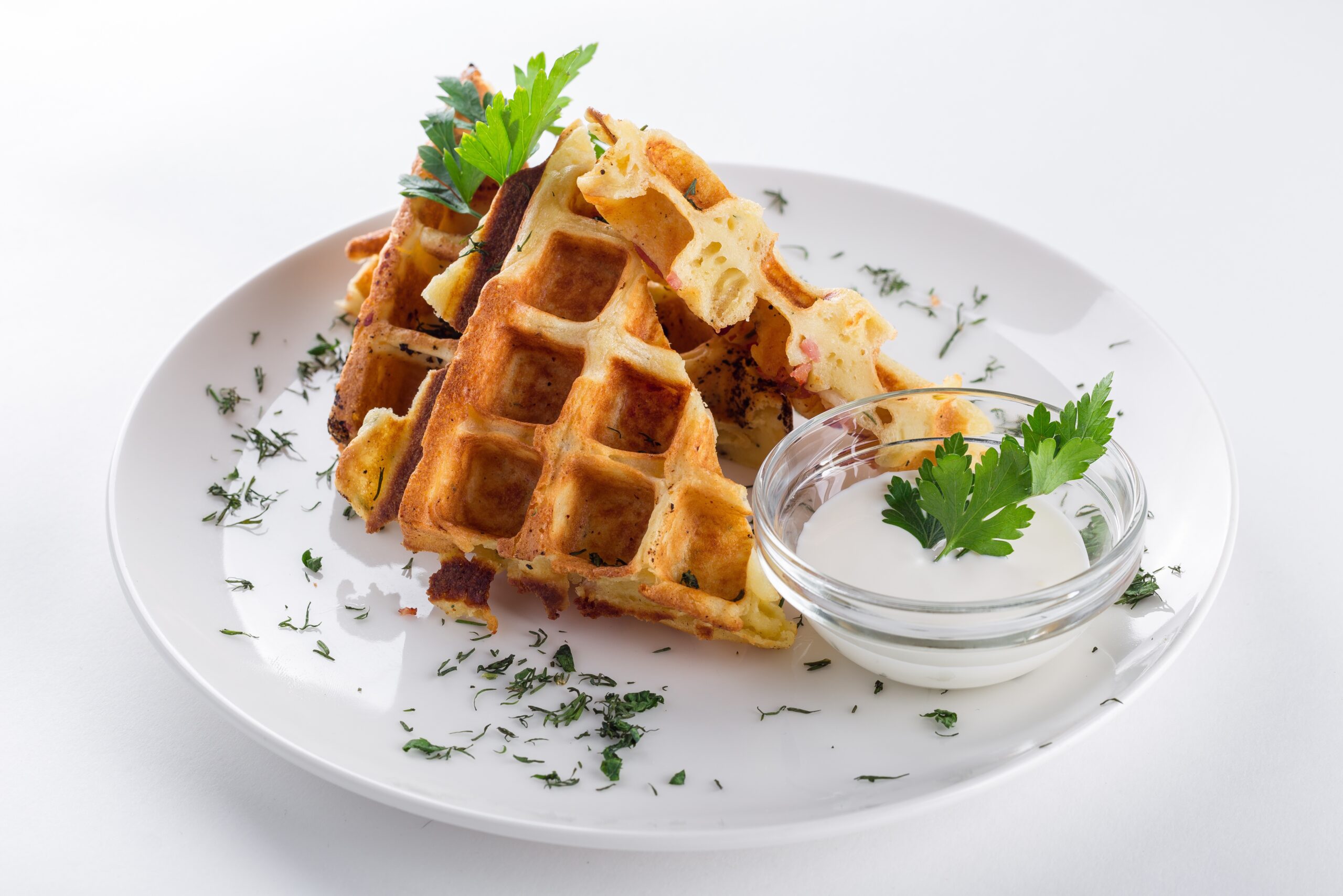 waffles on a white plate to pair your distnict coffee with