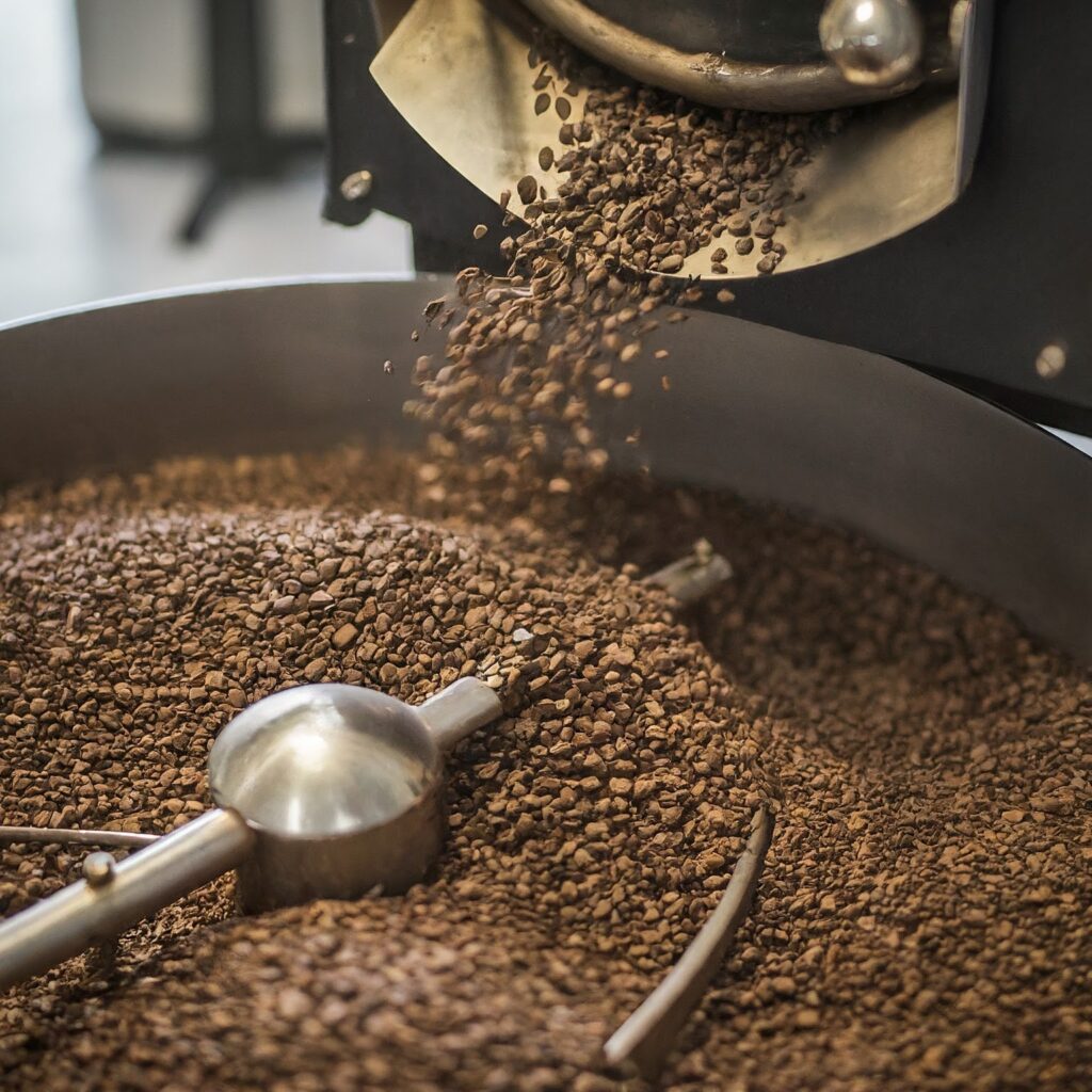 alt= Coffee beans being roasted and stirred in a local Mississauga coffee roastery machine