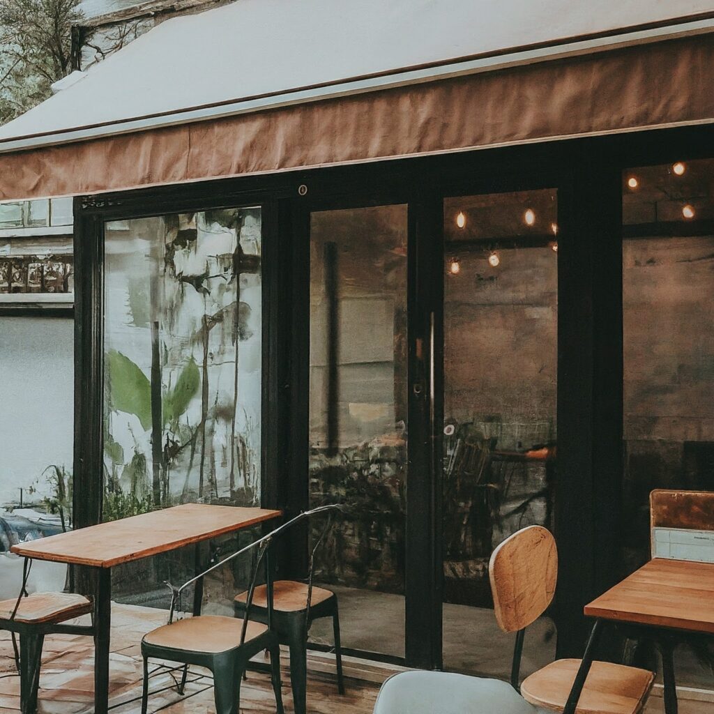 An inviting café scene with cozy seating, soft lighting, and a steaming cup of freshly brewed coffee, surrounded by delicious savory dishes, evoking a sense of exquisite and indulgence.