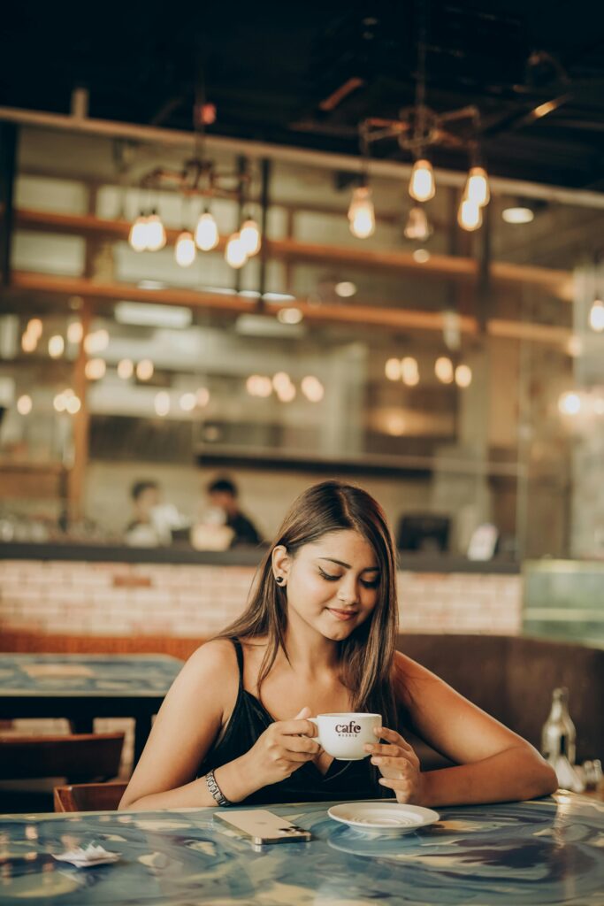 Girl drinking coffee in cafe